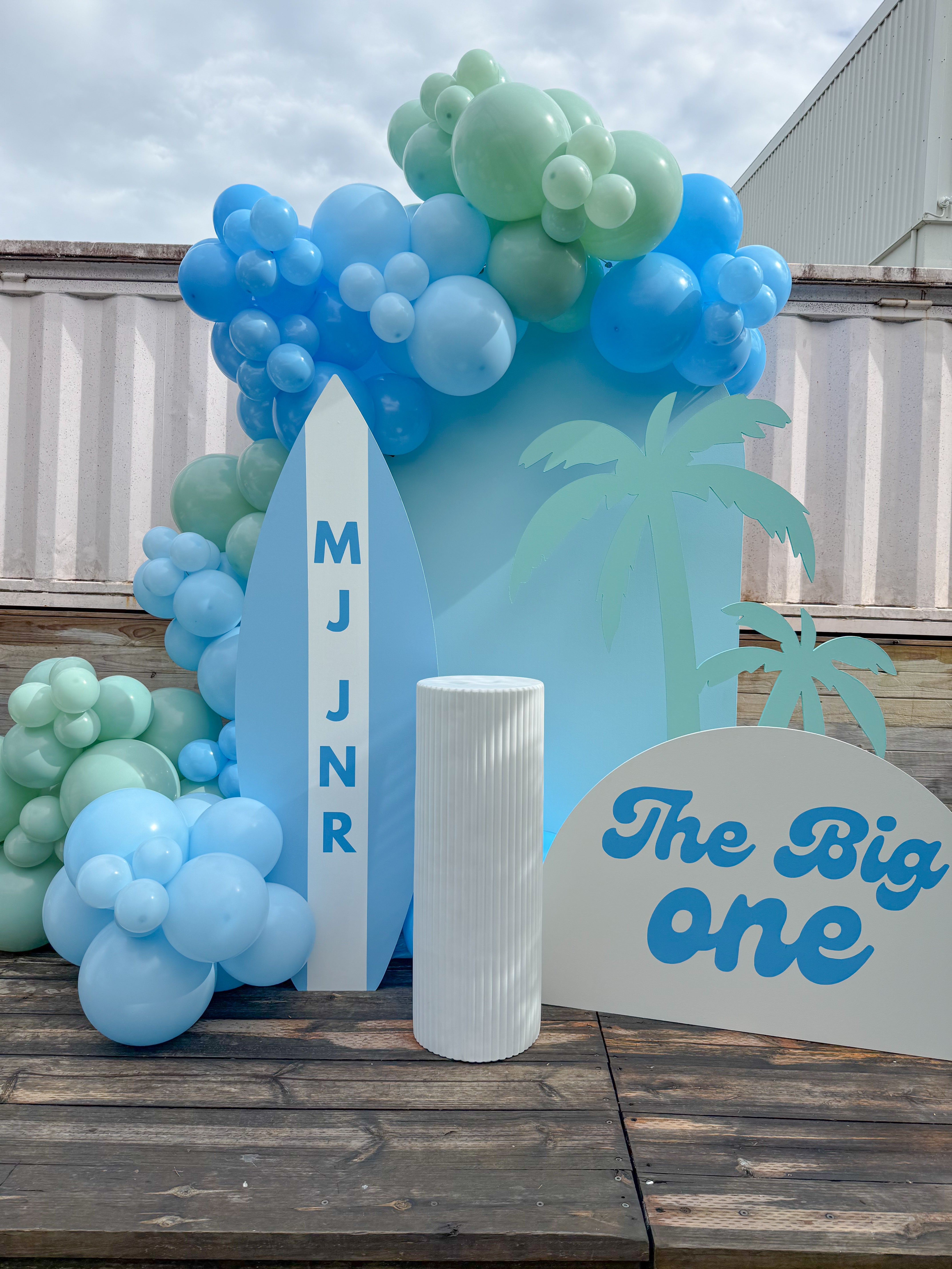 Surf themed birthday party setup with custom balloon garland, beach backdrop, and event styling on the Gold Coast