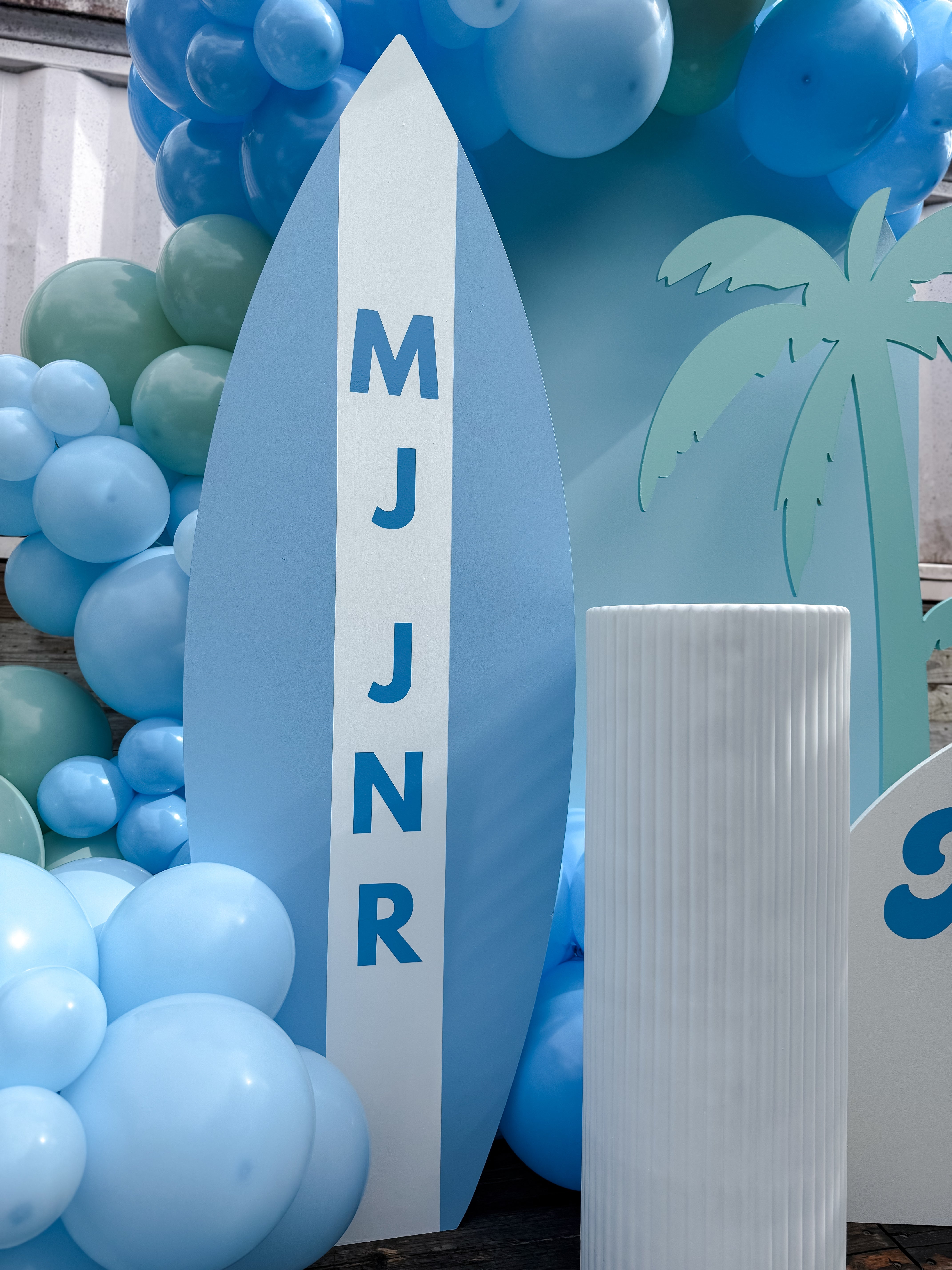 Surf themed birthday party setup with custom balloon garland, beach backdrop, and event styling on the Gold Coast