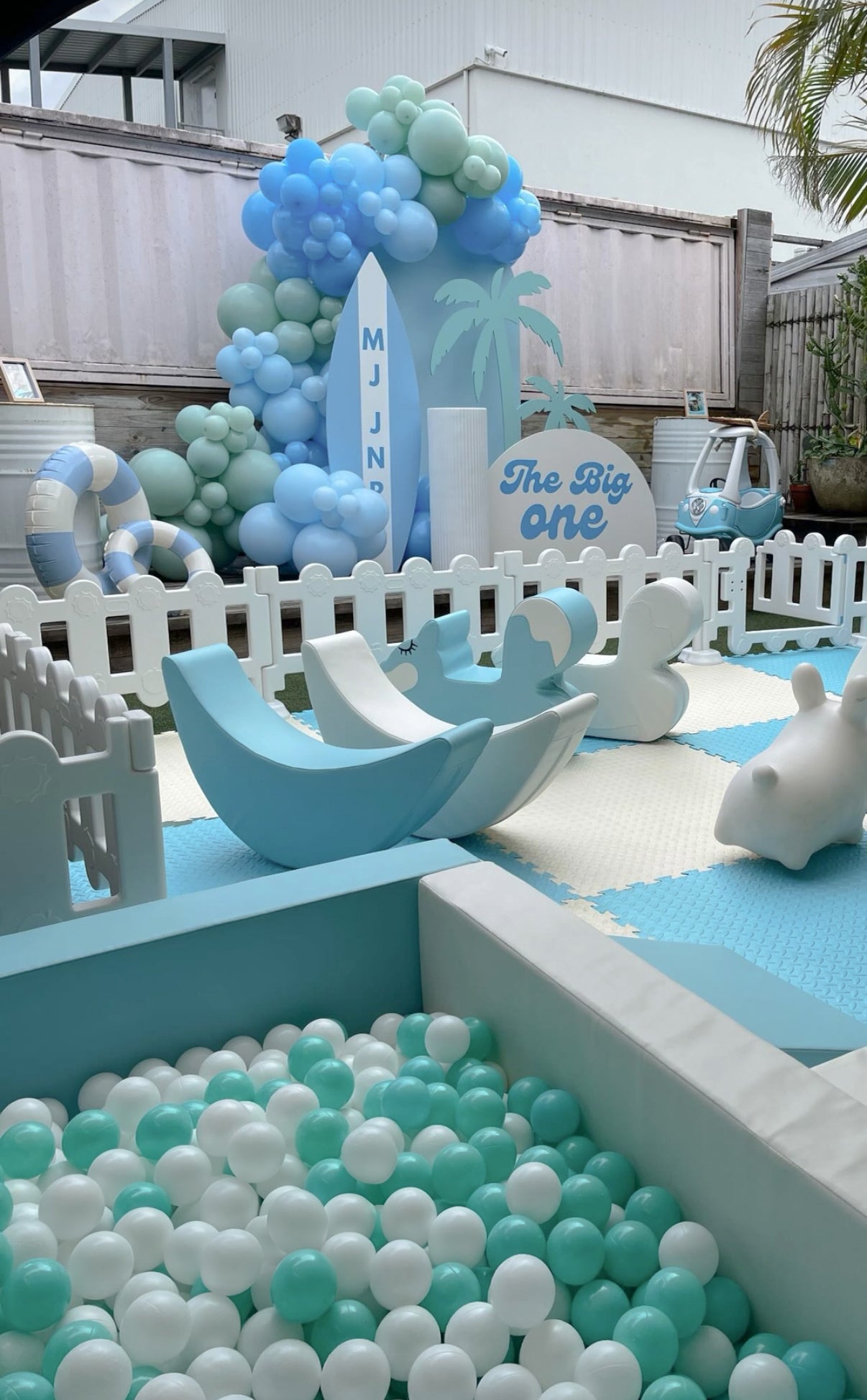 Surf themed birthday party setup with custom balloon garland, beach backdrop, and event styling on the Gold Coast