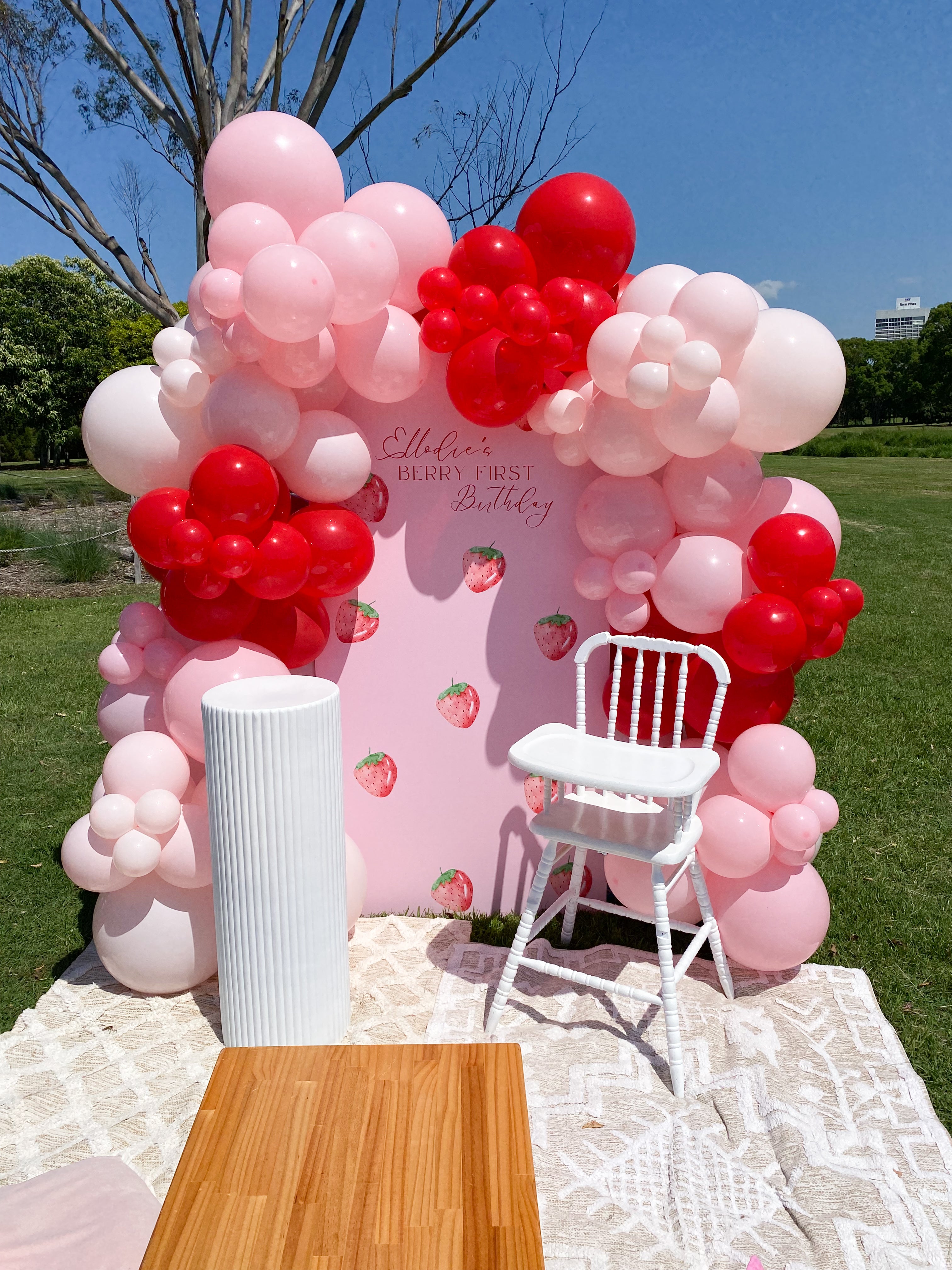Complete Berry First Birthday event styling with balloons, backdrop, and props on the Gold Coast